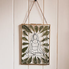 Load image into Gallery viewer, Handcrafted pressed flower frame featuring a drawing of a woman meditating, dried fern leaves inside the gold frame, perfect for home decor.