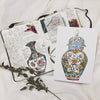 sketch book shown or original Limited edition prints showcasing the vibrant culture and intricate craftsmanship of Asia, capturing the elegance and natural beauty of traditional vases, inspired by personal travels