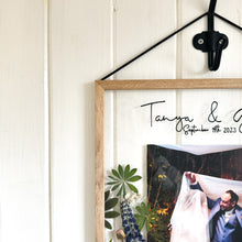 Load image into Gallery viewer, A close up corner image of handcrafted pressed flower frame featuring a couple's wedding photo, vibrant lupins and pink roses, perfect for home decor.