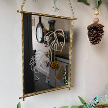 Load image into Gallery viewer, Handmade mirror with a stunning hand-engraved Monstera leaf design, crafted from golden metal, combining functionality with artistic flair to brighten up any home.