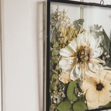 Load and play video in Gallery viewer, Overview of Bespoke handmade meadow frame showcasing delicately pressed wildflowers, capturing the essence of nature in square black frame