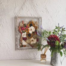 Load image into Gallery viewer, Bespoke handmade pressed flower frame featuring personally picked and arranged flowers, set in a hand-soldered silver frame, perfect for celebrating special moments and adding elegance to any home