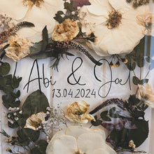 Load image into Gallery viewer, Close up of handcrafted pressed flower frame for wedding preservation. Handwritten couples name and date featured. With a wedding bouquet secured in place, perfect for home decor.
