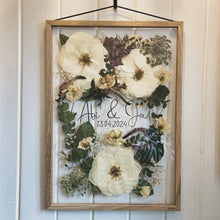 Load image into Gallery viewer, Handcrafted pressed flower frame for wedding preservation. Handwritten couples name and date featured. With a wedding bouquet secured in place, perfect for home decor.
