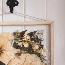 Load image into Gallery viewer, A close up of the corner of handcrafted pressed flower frame featuring a bridal bouquet which has carefully be pressed into a Ash wood frame.
